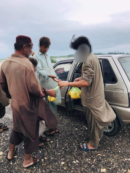 Essenspakete werden an mehrere Männer* verteilt (Foto: WSF)