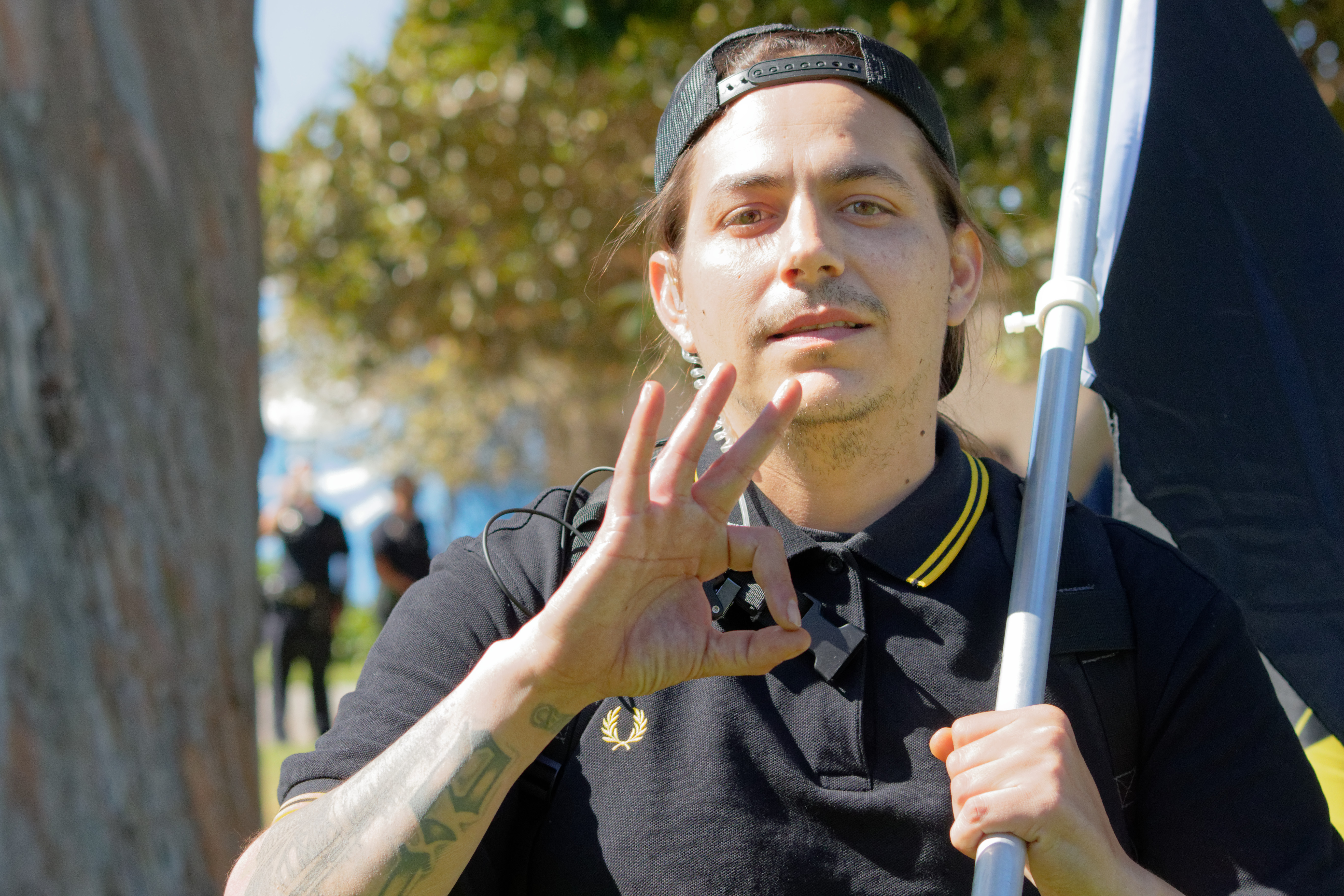 Brandon Revering throwing up a "white power" hand sign