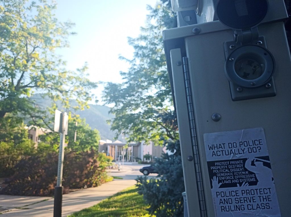 what do police actually do? sticker with boulder justice center in background