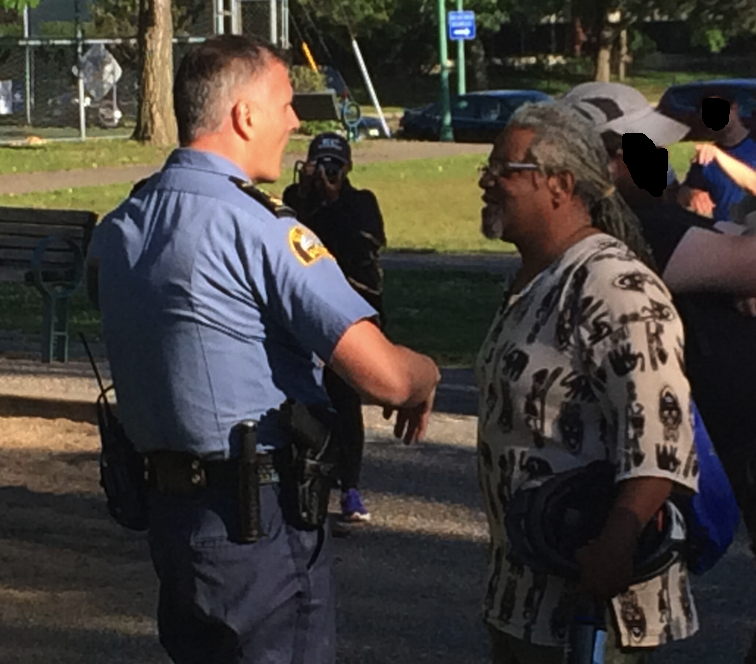 SPPD officer chats with protesters at Hamline Park.